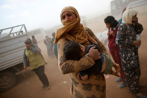 A Kurdish Syrian refugee waits for transport during a sand storm on the Turkish-Syrian border near the southeastern town of Suruc in Sanliurfa province, September 24, 2014. The United Nations refugee agency said on Tuesday it was making contingency plans in case all 400,000 inhabitants of the Syrian Kurdish town of Kobani fled into Turkey to escape advancing Islamic State militants.           REUTERS/Murad Sezer (TURKEY  - Tags: POLITICS TPX IMAGES OF THE DAY CIVIL UNREST CONFLICT)   - RTR47JGB