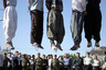 ** GRAPHIC CONTENT ** Iranian police officers and others view the scene as five convicted criminals are hanged in a neighborhood of Mashad, 1,000 kilometers (620 miles) northwest of Tehran, Iran, Wednesday Aug. 1, 2007. In the second round of collective executions in ten days, Iran on Wednesday publicly hanged 7 criminals convicted on various charges of rape, robbery and kidnapping, according to reports on the official web-site of state broadcasting company. (AP Photo/Halabisaz)