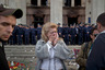 A woman cries back dropped by police troops guarding the burnt trade union building in Odessa, Ukraine, Saturday, May 3, 2014, where more than 30 people died trying to escape during clashes the day before. Odessa had been largely tranquil since the February toppling of President Viktor Yanukovych, who fled to Russia. But clashes erupted Friday between pro-Russians and government supporters in the key port on the Black Sea coast, located 550 kilometers (330 miles) from the turmoil in the east. (AP Photo/Vadim Ghirda)