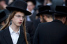 An Ultra-Orthodox Jew attends a prayer as he and others gather in the religious neighborhood of Mea Shearim to protest against summer events organized by the city council, Jerusalem