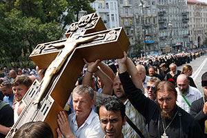 Orthodox believers and clergymen participate in a procession in downtown Kiev, Ukraine, Wednesday, July 27, 2016, in observance of the holiday marking the adoption of Christianity by what is now Russia and Ukraine in the 10th century. They are to commemorate the day at the hillside monument in central Kiev to Saint Volodymyr, the prince who enacted the adoption of Christianity. (AP Photo/Sergei Chuzavkov)