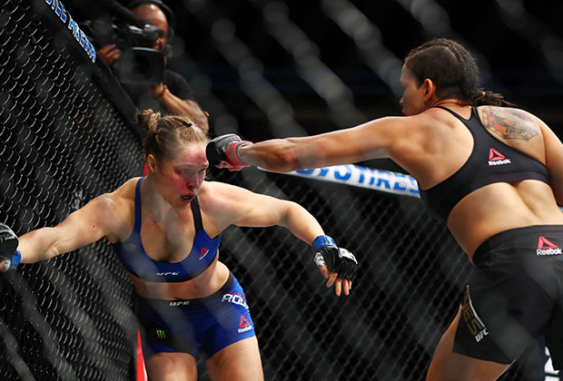 Amanda Nunes lands punches against Ronda Rousey during UFC 207 at T-Mobile Arena