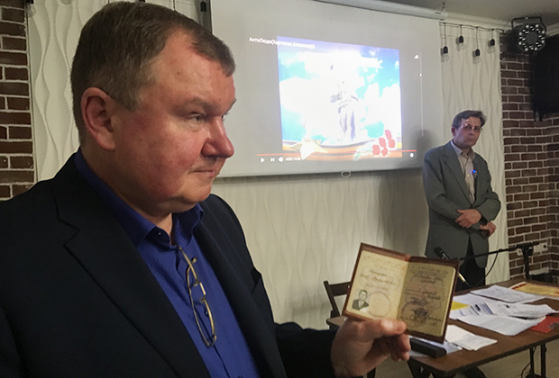 Сергей Тараскин показывает свой советский военный билет, на основе которого объявил себя врио президента СССР