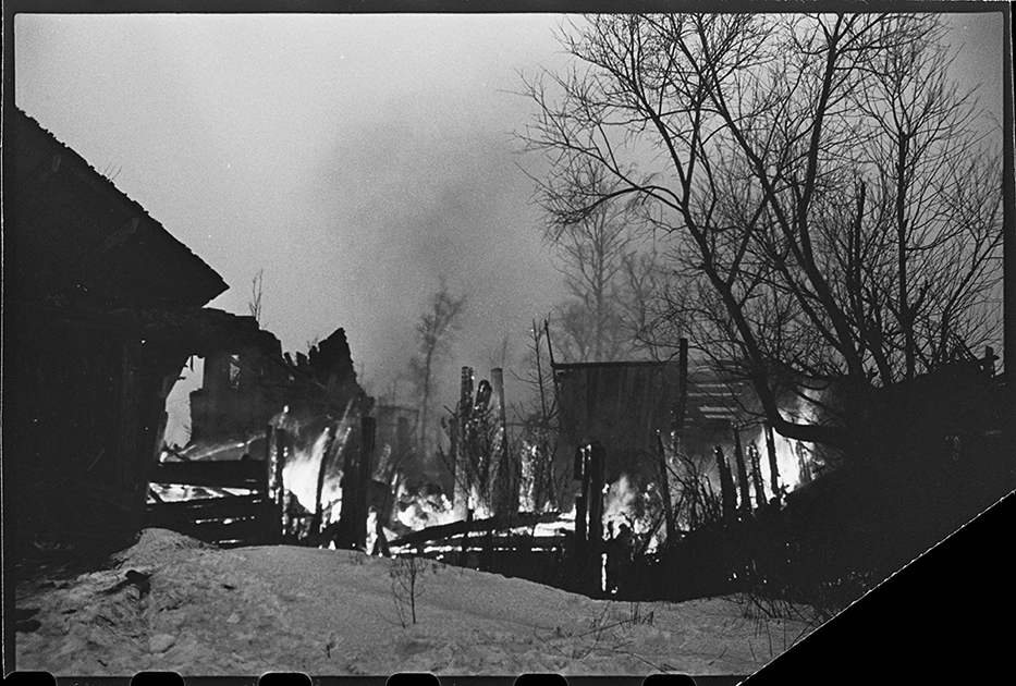 На путях отступления немцев в районе Гатчины горят подожженные гитлеровцами дома на Красной улице, переименованной немцами в Штутгартштрассе. Ленинградский фронт, 1944 год.
