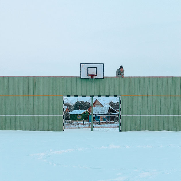 Фотограф Александр Васильев позирует на спортивной площадке речевой школы-интерната.