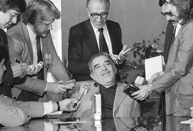 Colombian novelist Gabriel Garcia Marquez is surrounded by newsmen, date and location unknown.