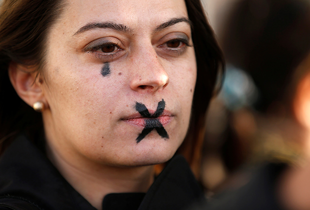 A woman with a tear and a cross painted on her face demonstrates during a gathering against gender-based and sexual violence in Marseille, France, October 29, 2017. REUTERS/Jean-Paul Pelissier