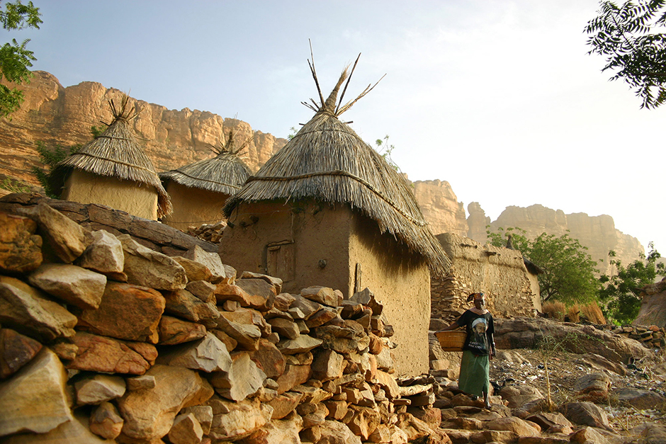 Раннее утро в Сонго. Здесь, на юго-востоке Мали, живут догоны. Этот народ проживает компактно, добраться к ним не так просто. На снимке дом местной жительницы, семья которой приютила фотографа на ночь. Женщина отправляется за водой.