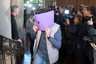 A defendant covers his face when arriving at the court in Berlin, Germany, Thursday, Jan. 10, 2019 for the first day of the trial over the brazen theft of a 100-kilogram (221-pound) Canadian gold coin from a Berlin museum. The "Big Maple Leaf" coin, worth several million dollars, was stolen from the Bode Museum in March 2017.