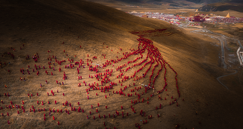 «Красная река веры» Лифеня Чена. Тысячи буддистских женщин выстроились в линии на пути в горы, где они займутся практикой Дхармы Да Юань Шень Хуй. Провинция Сычуань, Китай. 

