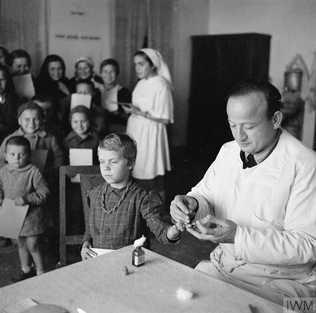 Польский врач в медицинском центре берет анализ крови у девочки-сироты, подвергшейся депортации в 1939 году и эвакуированной из СССР в Иран. Тегеран, декабрь 1942 года. 