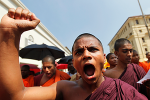A Sri Lankan Buddhist monk shouts slogans outside the Indian High Commission to Sri Lanka during a protest in Colombo March 20, 2013. Buddhist monks protested since Tuesday against two separate attacks on Sri Lankan Buddhist monks who were in Chennai for education visits, and demanded the Indian government to take action on these attacks, according to the demonstrators. REUTERS/Dinuka Liyanawatte (SRI LANKA - Tags: POLITICS CIVIL UNREST RELIGION) - GM1E93K18HZ01