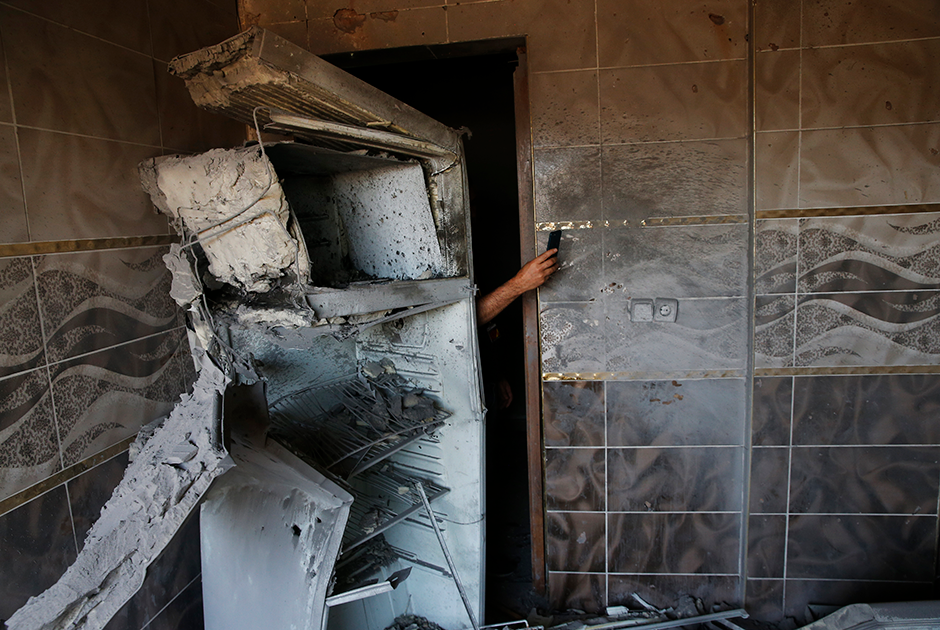 Турок пытается сфотографировать повреждения в доме после минометного обстрела города Акчакале сирийскими курдами. Мишенями октябрьского минометного обстрела стали административные здания. Кроме того, были обстреляны журналисты, которые вели трансляцию с крыши одного из домов на границе Турции и Сирии.
