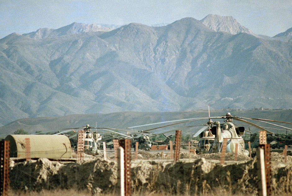 Various types of Soviet military helicopters, including a Mi-24 gunship, background center, are parked outside Kabul Airport, April 22, 1988. An estimated 115,000 Soviet troops still remain in Afghanistan but they will begin leaving May 15 under a U.N. mediated withdrawal agreement signed in Geneva on April 14. (AP Photo/Liu Heung-Shing)