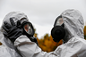Specialists adjust protection gear during a civil protection functional exercise in case of nuclear disaster in Svencionys, Lithuania October 2, 2019.