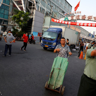 Люди и охранники перед закрытым рынком в Пекине