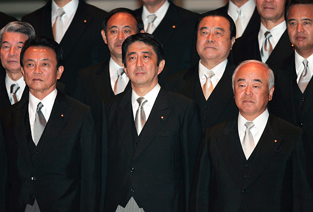 Синдзо Абэ в окружении министров в 2006 году. За его правым плечом стоит Ёсихидэ Суга