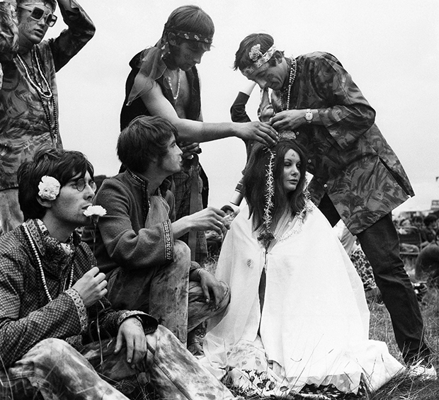 Hippies decorate each other with flowers on August 26, 1967 at Woburn Abbey, stately home of the Duke of Bedford at Woburn, England. (AP Photo)