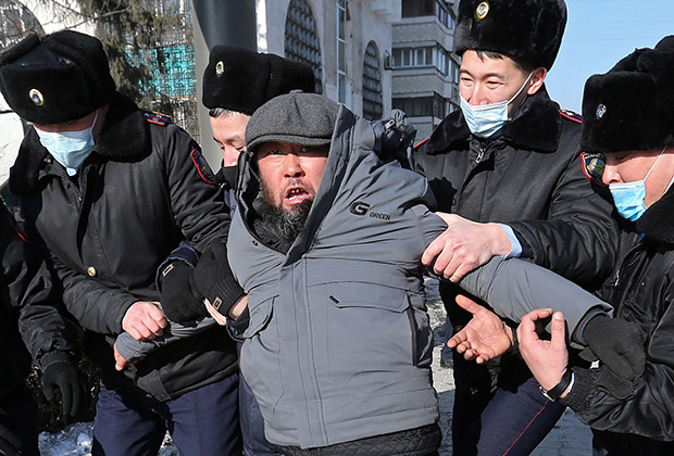 A protester is taken away by law enforcement officers during a rally held by opposition supporters on the parliamentary election day in Almaty, Kazakhstan January 10, 2021. 