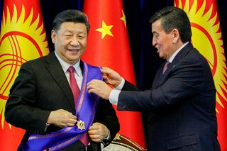 Экс-президент Киргизии Сооронбай Жээнбеков награждает председателя КНР Си Цзиньпина орденом Манас. Бишкек, 2019 год