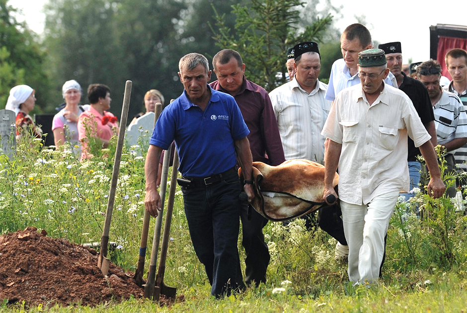 Люди несут носилки с телом погибшего во время крушения теплохода «Булгария»