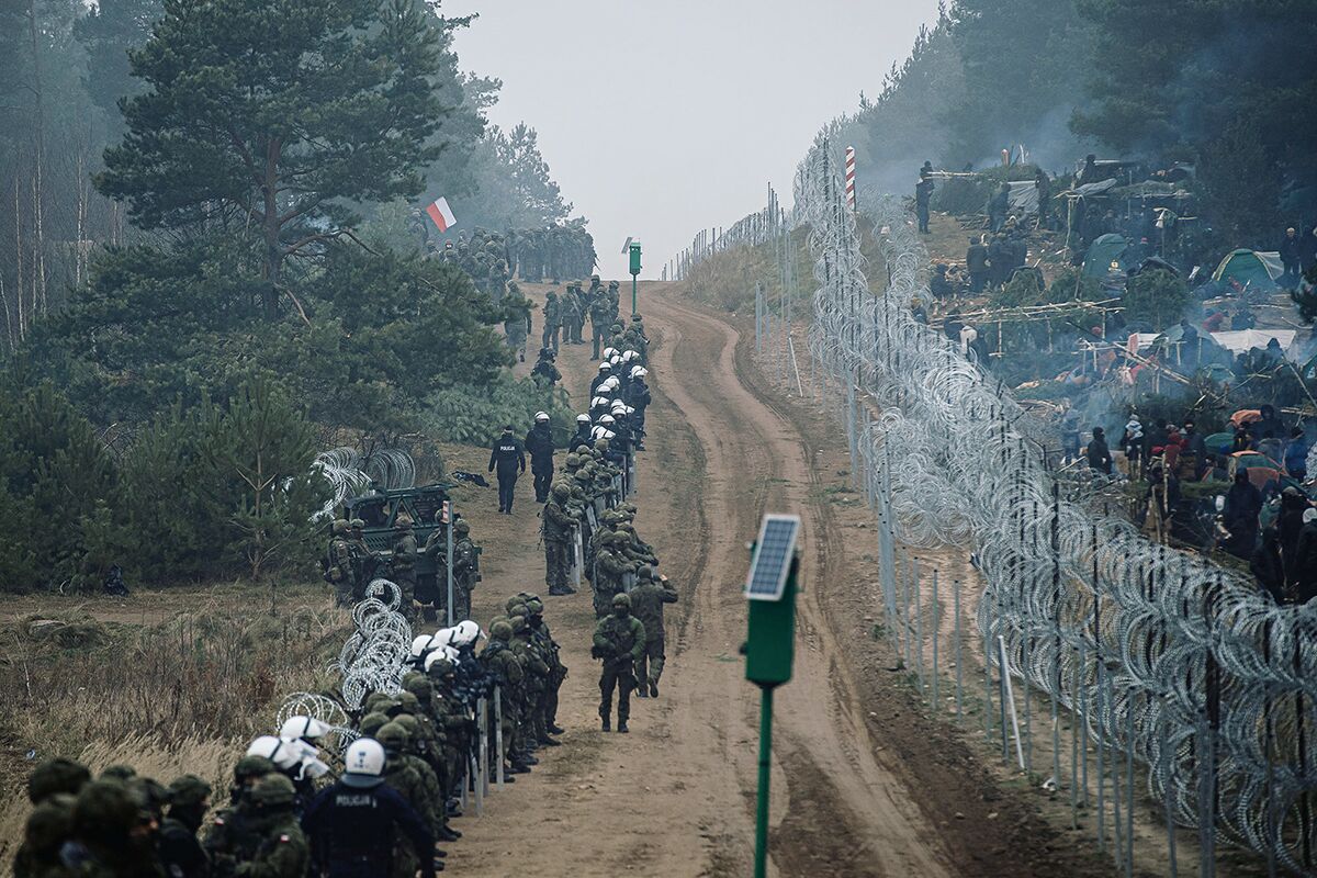 Польские солдаты и полицейские охраняют границу с Белоруссией неподалеку от пункта пропуска Брузги — Кузница, 11 ноября 2021 года