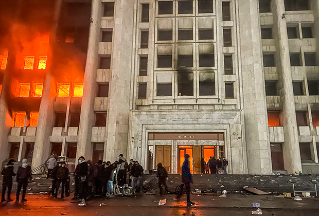 Протестующие возле горящего здания мэрии (акимат) Алма-Аты