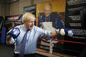 MANCHESTER, ENGLAND - NOVEMBER 19: Britain's Prime Minister Boris Johnson poses for a photo wearing boxing gloves emblazoned with "Get Brexit Done" during a stop in his General Election Campaign trail at Jimmy Egan's Boxing Academy on November 19, 2019 in Manchester, England. Britain goes to the polls on Dec.12. (Photo by Frank Augstein - WPA Pool/Getty Images)