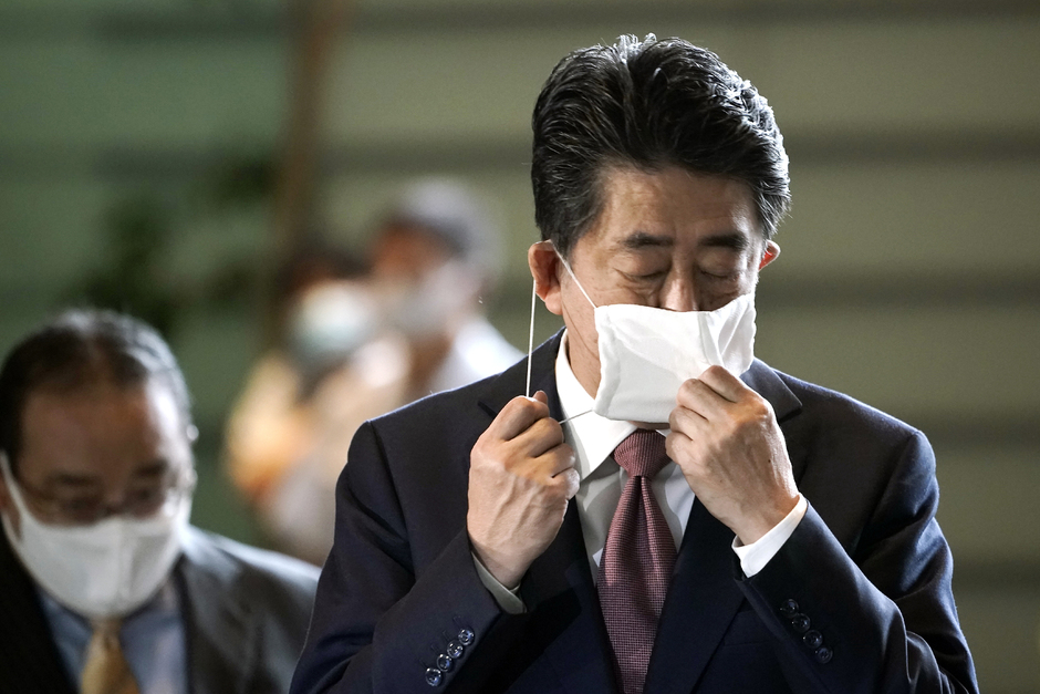 Абэ снимает маску по прибытии в канцелярию премьер-министра в 2020 году