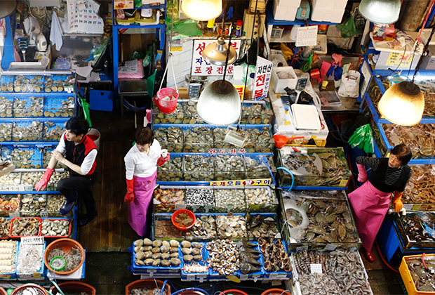 Fish dealers wait for customers at a fishery market in Seoul