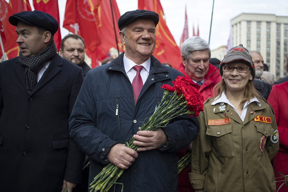 Communist Party leader Gennady Zyuganov, center, walks towards the Tomb of Soviet founder Vladimir Lenin during a demonstration marking the 102nd anniversary of the 1917 Bolshevik revolution in Red Square, in Moscow, Russia, Tuesday, Oct. 29, 2019. (AP Photo/Pavel Golovkin)