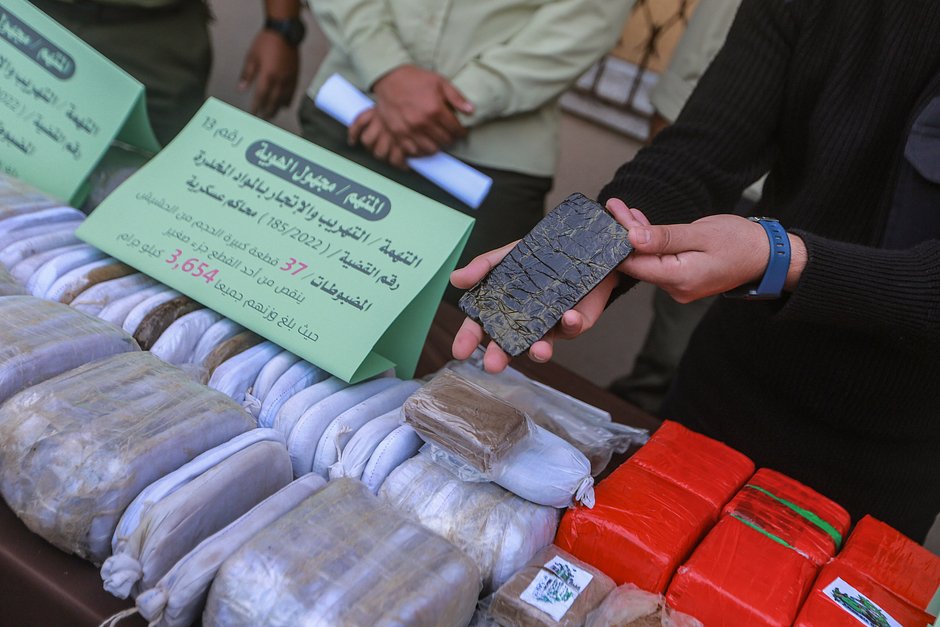 Силы безопасности ХАМАС охраняют выставку гашиша, марихуаны и таблеток трамадола, изъятых пограничниками. Газа, 21 октября 2021 года