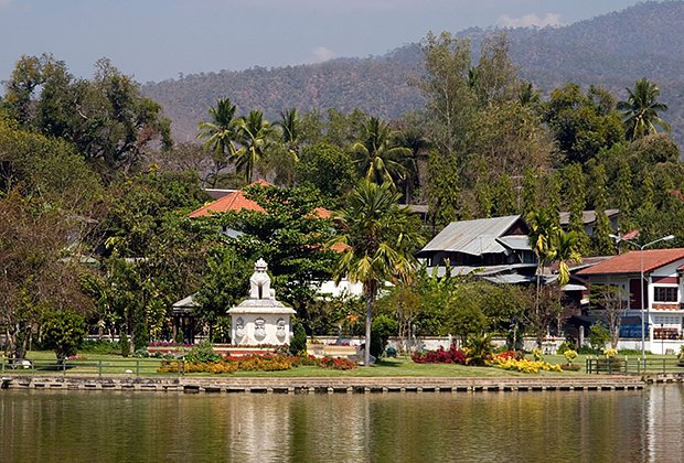 A Beautiful Flower Garden Near A Lion Statue Is Part Of The Urban Landscape At Jong Kham Lake In Mae Hong Son, Thailand.