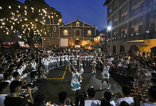 A marching band performs after the first dawn Mass at the St. Joseph Parish Church in Las Pinas city, Philippines on Friday, Dec. 16, 2022. Filipinos attend nine consecutive dawn Masses before Christmas as part of traditional Filipino practice in this largely Roman Catholic nation as COVID restrictions eased in the country. (AP Photo/Aaron Favila)