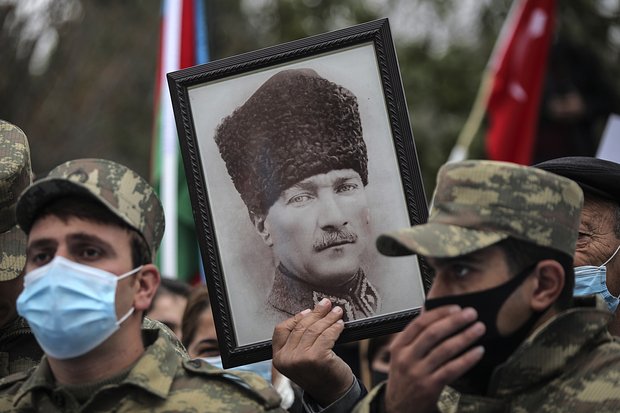 Азербайджанские солдаты держат портрет основателя Турции Мустафы Кемаля Ататюрка во время празднования передачи Лачинского района под контроль Азербайджана, Агджабеди, Азербайджан, 1 декабря 2020 года. Фото: Emrah Gurel / AP