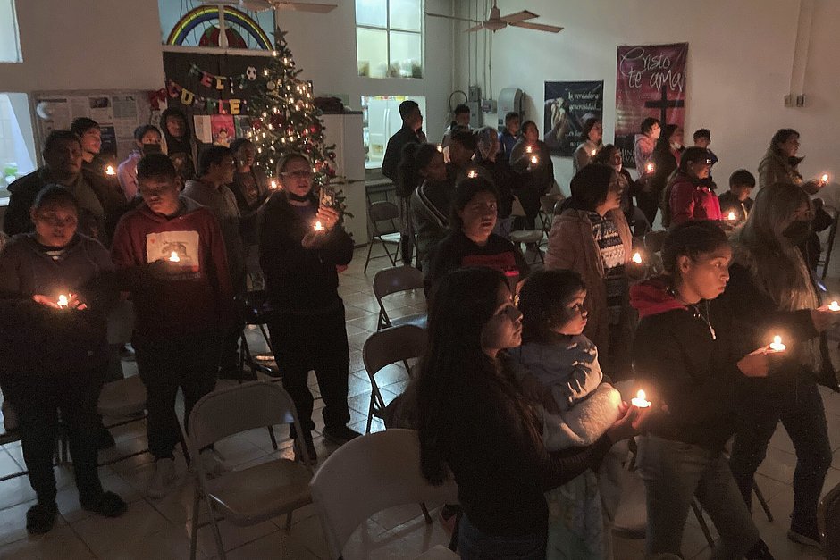 Церемония зажжения свечей в небольшой методистской церкви при приюте для мигрантов в преддверии Рождества, Сьюдад-Хуарес, Мексика, 22 декабря 2022 года