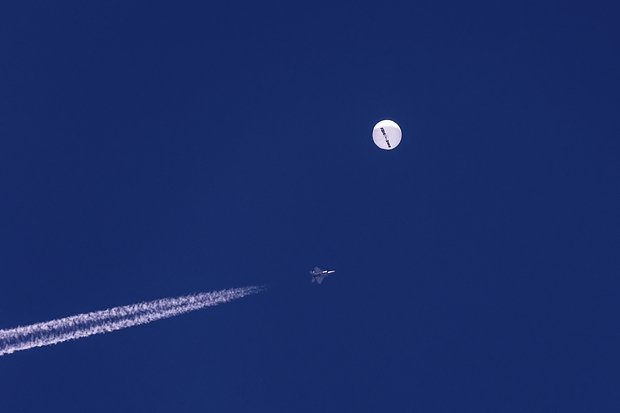 Истребитель пролетает рядом с большим воздушным шаром, дрейфующим над Атлантическим океаном недалеко от побережья Южной Каролины, 4 февраля 2023 года. Фото: Chad Fish / AP