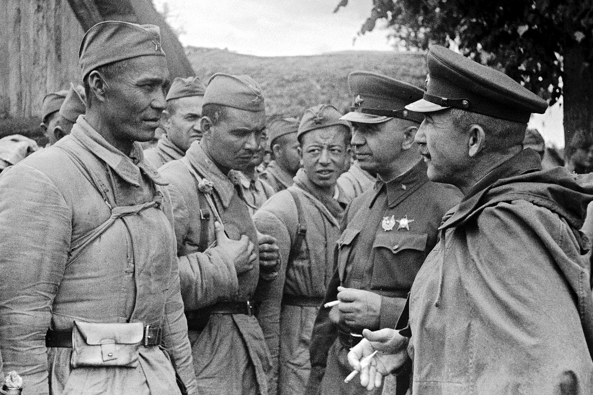 Генерал Павел Белов (крайний справа) и бригадный комиссар Алексей Щелаковский беседуют с бойцами-разведчиками