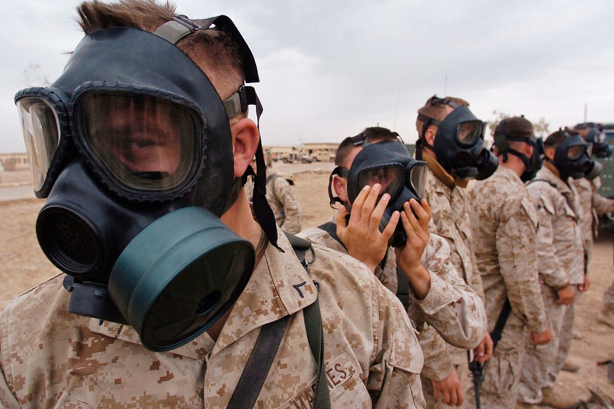 Морские пехотинцы 1-го экспедиционного корпуса морской пехоты США (I MEF) проверяют свои противогазы в рамках подготовки к полномасштабному наступлению против иракских повстанцев в городе Фаллуджа, Ирак, 1 ноября 2004 года