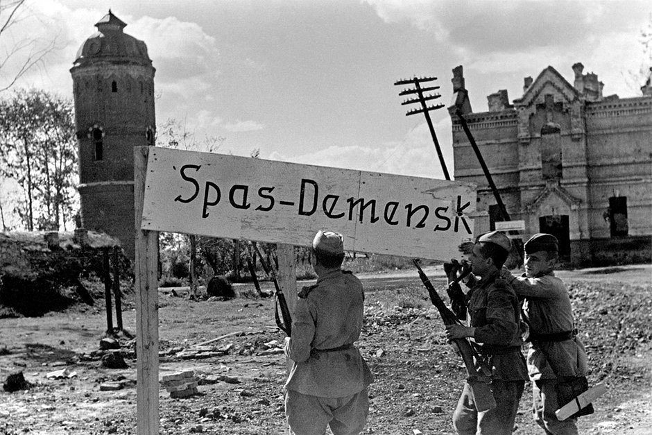 Советские бойцы снимают немецкую табличку в освобожденном Спас-Деменске, август 1943 года