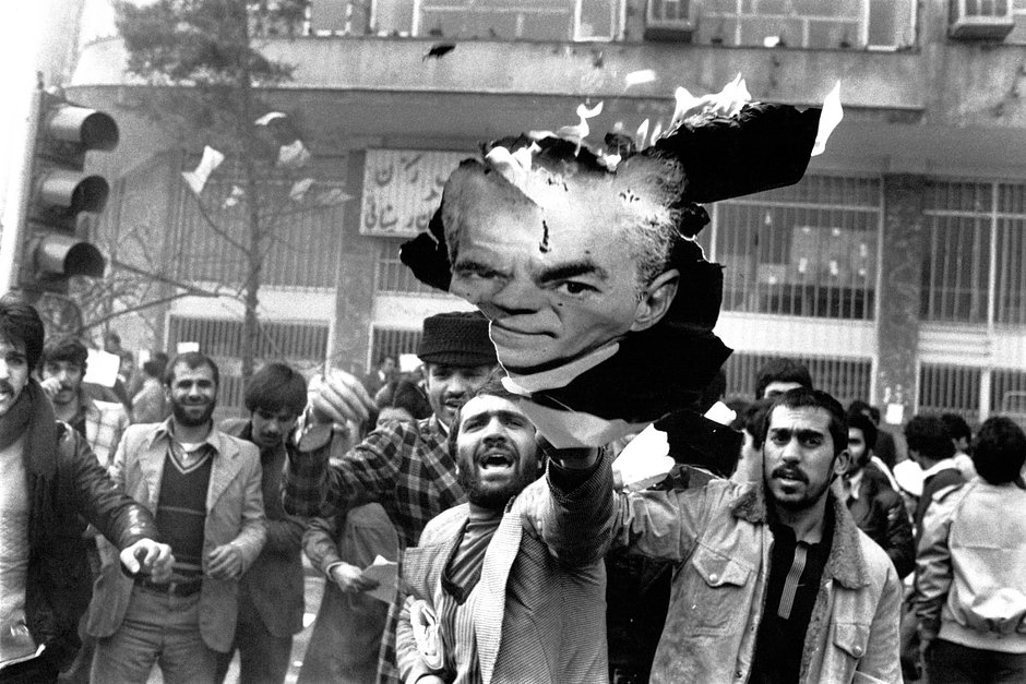 Революционеры сжигают портрет шаха Мохаммеда Резы Пехлеви в Тегеране во время Исламской революции, февраль 1978 года