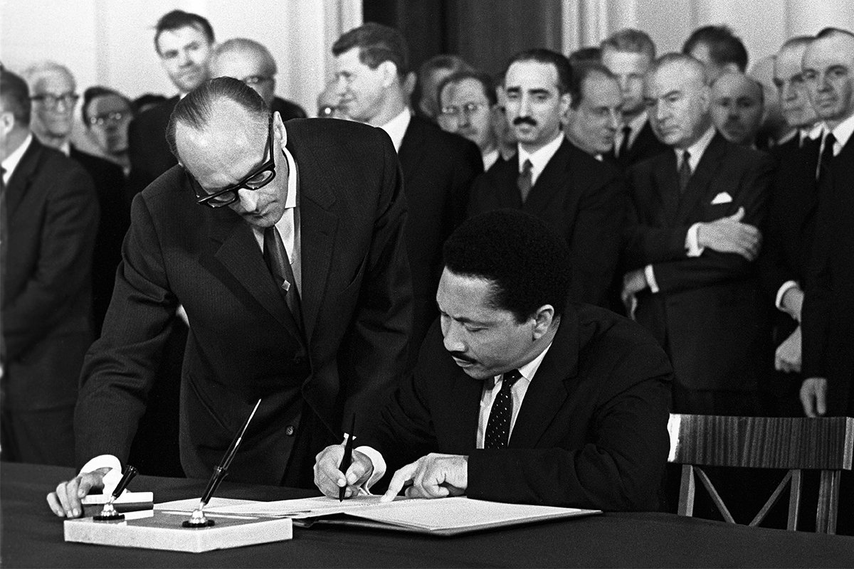 Посол Ганы Джон Эллиот подписывает Договор о запрещении испытаний ядерного оружия в атмосфере, в космическом пространстве и под водой, 8 августа 1963 года