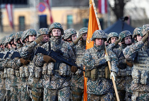 Latvian oldiers march during a military parade to celebrate Latvia's centenary in Riga, Latvia