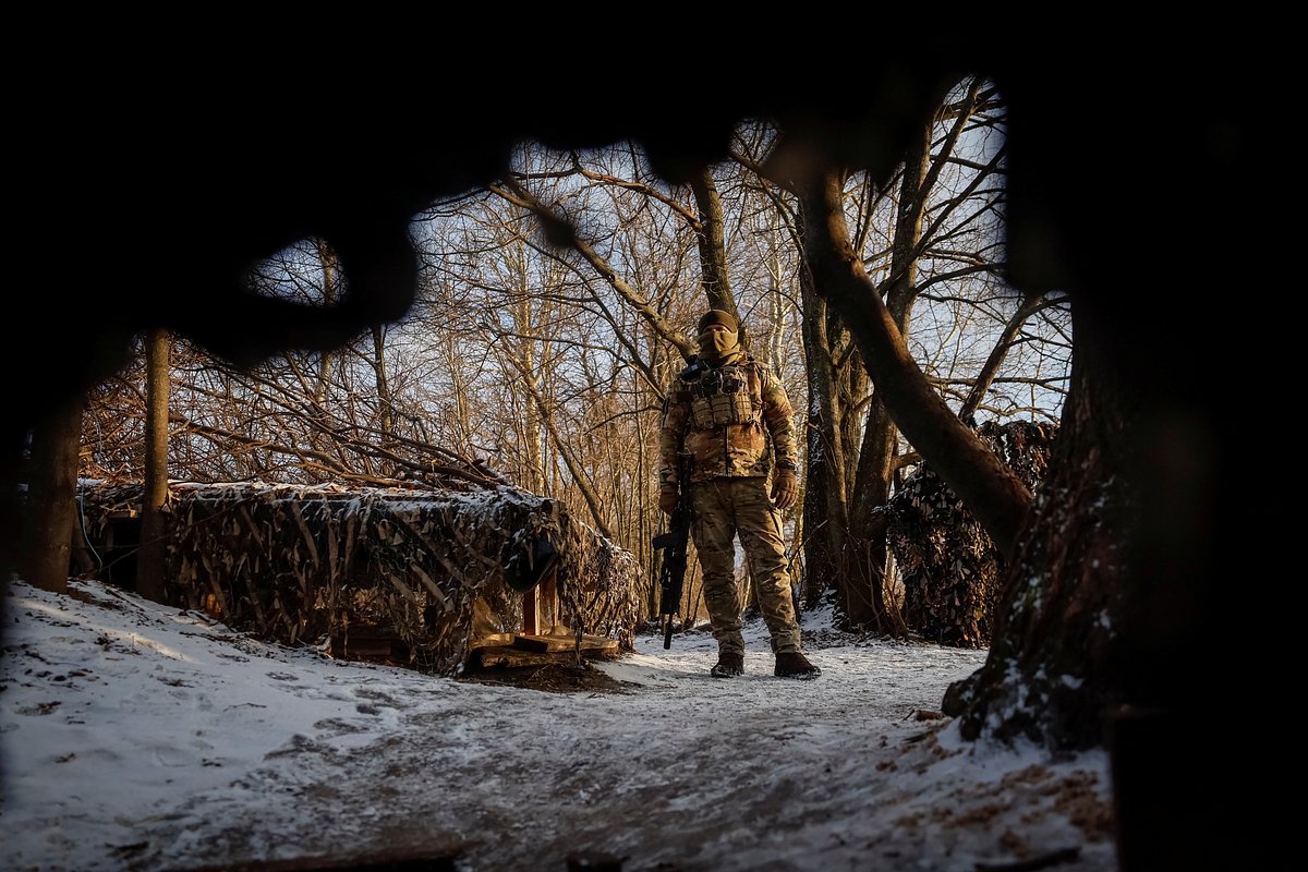 A Ukrainian serviceman stands at his position at a front line on the border with Russia