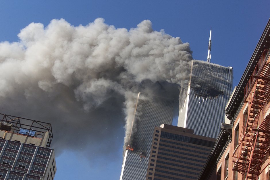 Дым над горящими башнями-близнецами Всемирного торгового центра после теракта в Нью-Йорке, США, 11 сентября 2001 года 