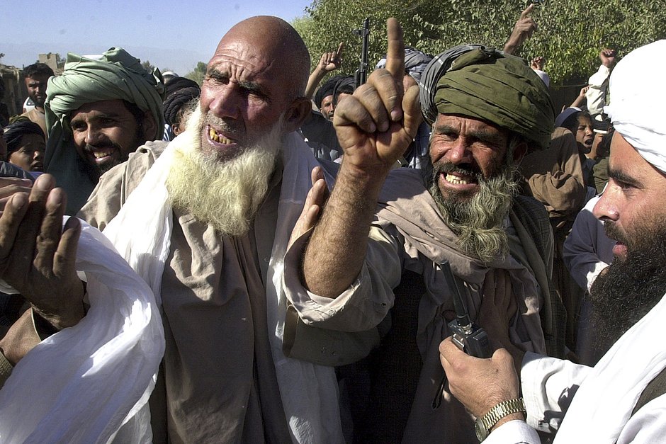 Поддерживающие талибов афганцы выкрикивают антиамериканские лозунги иностранным журналистам в деревне Батва Ват, в 20 километрах к западу от Джелалабада, Афганистан, 14 октября 2001 года
