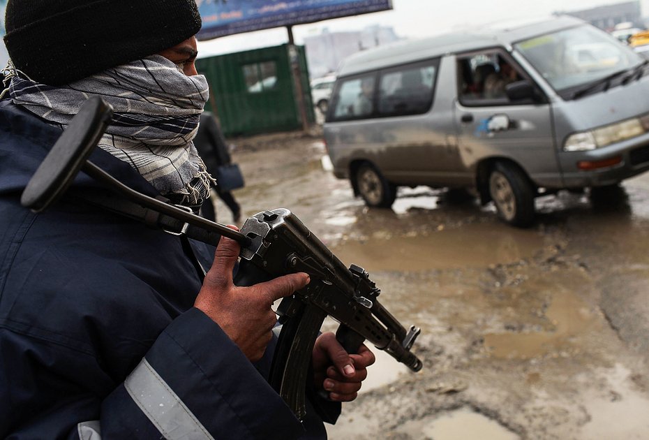 Сотрудник Афганской национальной полиции (АНП) выслеживает подозрительные автомобили в Кабуле, Афганистан, 28 января 2010 года