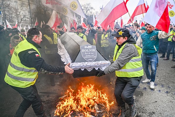 Польские фермеры принимают участие в акции протеста против зеленого курса ЕС и импорта украинского зерна. Надпись на макете гроба «Фермер. Он прожил 20 лет, зеленая земля убила его»