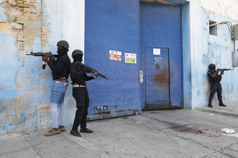 Национальная полиция охраняет пустое здание национальной тюрьмы после пожара, Порт-о-Пренс, Гаити, 14 марта 2024 года