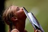 Maria Sharapova of Russia kiss her trophy after her victory against Serena Williams of USA in the ladies final match at the Wimbledon Lawn Tennis Championship on July 3, 2004 at the All England Lawn Tennis and Croquet Club in London. Sharapova won 6-1 6-4